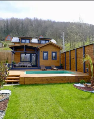 a log cabin with a pool in a yard at Sapanca Balkaya Bungalov in Sapanca