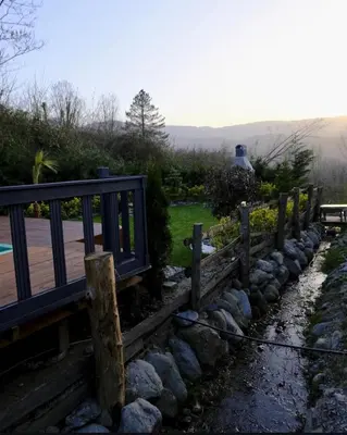 a wooden fence next to a walkway with rocks at Sapanca Balkaya Bungalov in Sapanca