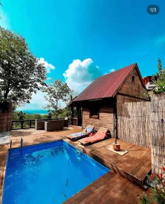a swimming pool on a wooden deck next to a house at Sapanca Balkaya Bungalov Dağ evi in Sapanca
