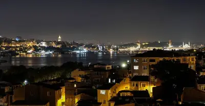 a view of a city at night with the water at New Stylish Apartment with Panoramic Views in Istanbul