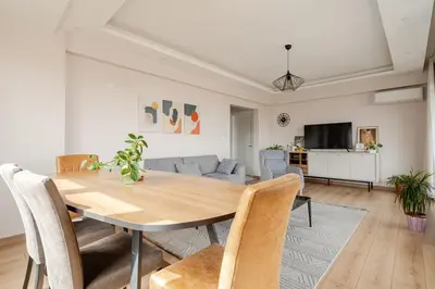 a dining room with a table and a couch at New Stylish Apartment with Panoramic Views in Istanbul