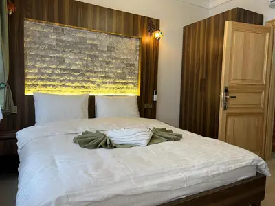 a bedroom with a large white bed with a large window at Arkeon Bosphorus Hotel & Suites in Istanbul