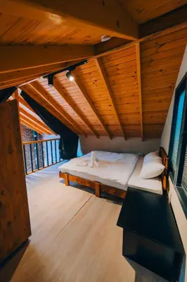 a bed in a room with wooden ceilings at Sapancaacarkonaklama in Sapanca