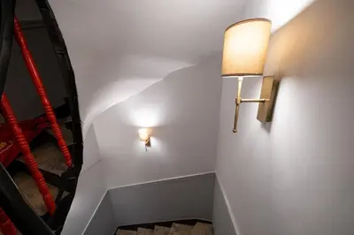 a hallway with a light on the wall and a mirror at King Suit Beşiktaş apart in Istanbul