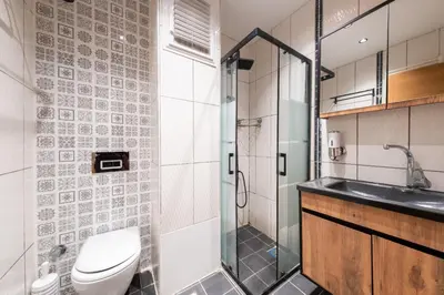 a bathroom with a toilet and a sink and a shower at King Suit Beşiktaş apart in Istanbul