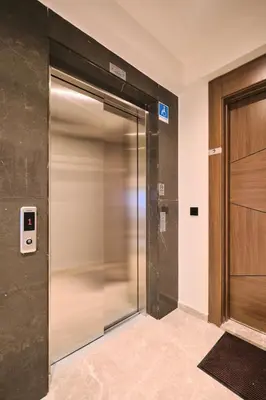 an elevator in a building with a glass door at BSY's Stylish 1BR,2BR ,3BR Apartments in Brand New Building in Istanbul