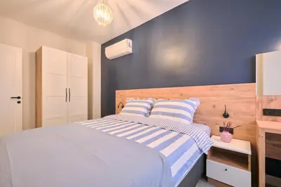 a bedroom with a bed and a blue wall at BSY's Stylish 1BR,2BR ,3BR Apartments in Brand New Building in Istanbul