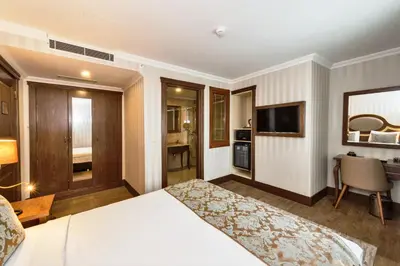 a hotel room with a bed and a desk at The Central Hotel in Istanbul
