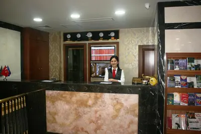 a woman standing behind a counter in a room at The Central Hotel in Istanbul