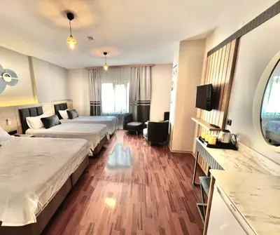 a hotel room with two beds and a television at İSTANBUL Taksim Palece OTEL in Istanbul