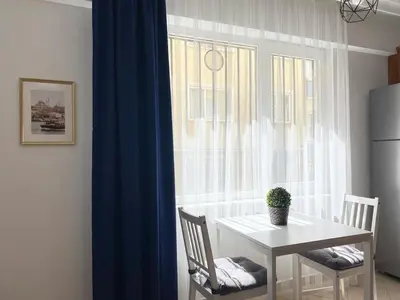 a white table and chairs in a kitchen with a window at Excelent Location & Spacious No3 in Istanbul
