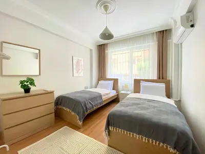 a bedroom with two beds and a mirror at Excelent Location & Spacious No3 in Istanbul