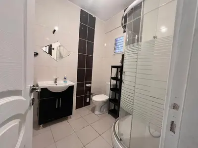 a bathroom with a sink and a toilet and a shower at Meryy Home in Istanbul