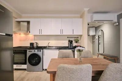 a kitchen and dining room with a table and chairs at House Kadıköy in Istanbul