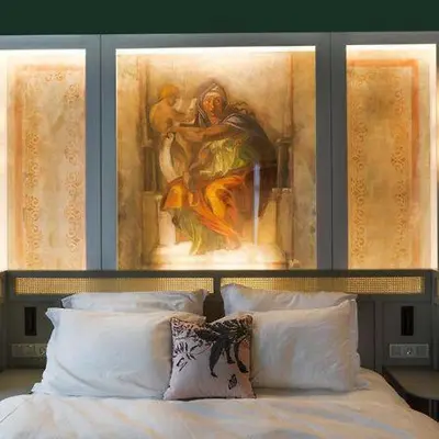 a bedroom with a painting above a bed with pillows at The Grand Baazar Suites in Istanbul