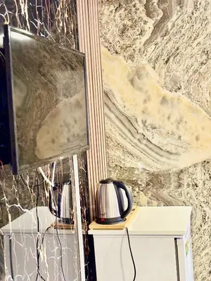 a flat screen tv sitting on a shelf next to a wall at Nera Otel in Istanbul