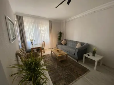 a living room with a couch and a table at ŞAH apartmanı in Istanbul