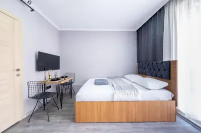 a bedroom with a bed and a desk and a tv at Lomend Hotels in Istanbul