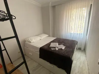 a bedroom with a bed with a ladder and a window at Şah in Istanbul