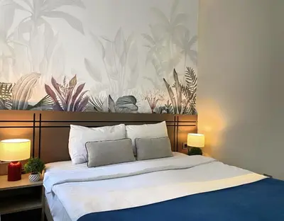 a bedroom with a large bed with a tropical wallpaper at Vion Hotel Taksim in Istanbul