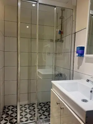 a bathroom with a glass shower and a sink at Vion Hotel Taksim in Istanbul