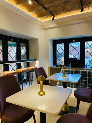 a waiting room with tables and chairs and stained glass windows at Vion Hotel Taksim in Istanbul