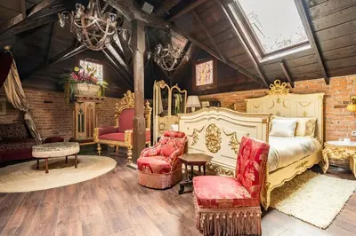 a bedroom with a bed and a couch and chairs at NOLD Suite in Istanbul