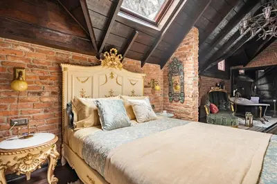 a bedroom with a bed and a brick wall at NOLD Suite in Istanbul