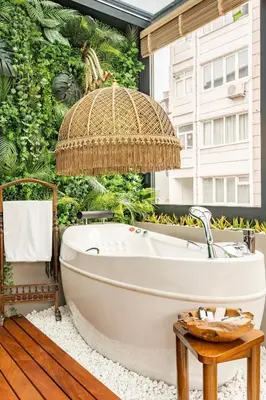 a bath tub in a bathroom with a wall of plants at NOLD Suite in Istanbul