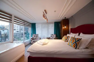 a bedroom with a large bed and a bath tub at Blue Mosq Pansiyon & Apart in Istanbul