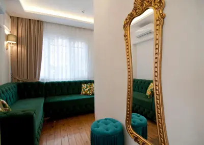 a living room with a green couch and a mirror at Blue Mosq Pansiyon & Apart in Istanbul