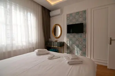 a bedroom with a white bed with towels on it at Blue Mosq Pansiyon & Apart in Istanbul