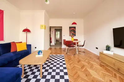 a living room with a blue couch and a table at Cihangir Pop Art Hideaway in Istanbul