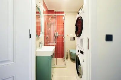 a bathroom with a sink and a washing machine at Cihangir Pop Art Hideaway in Istanbul