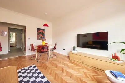 a living room with a large tv and a table at Cihangir Pop Art Hideaway in Istanbul