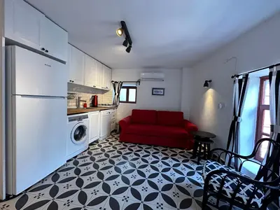 a living room with a red couch in a kitchen at Nefes Ada Taş Bina - Bahçe Katı in Istanbul