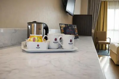 a tray with coffee cups and a coffee maker on a counter at Akgün Hotel Laleli Istanbul in Istanbul