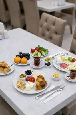 a table with plates of food on it at Akgün Hotel Laleli Istanbul in Istanbul