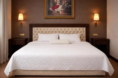 a bedroom with a large white bed with two night stands at Akgün Hotel Laleli Istanbul in Istanbul