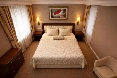a hotel room with a bed and a chair at Akgün Hotel Laleli Istanbul in Istanbul