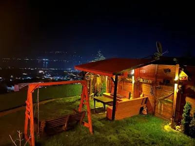 a cabin with a swing and a gazebo at night at Sapanca Turuncu Hobbit Evi in Sapanca