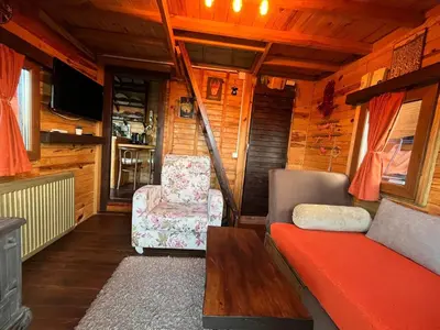 a living room with a couch and a chair at Sapanca Turuncu Hobbit Evi in Sapanca