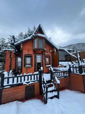a log cabin in the snow with a fence at Sapanca Turuncu Hobbit Evi in Sapanca