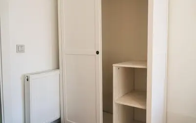 a closet with a white door and a shelf at Hill House Hostel in Istanbul