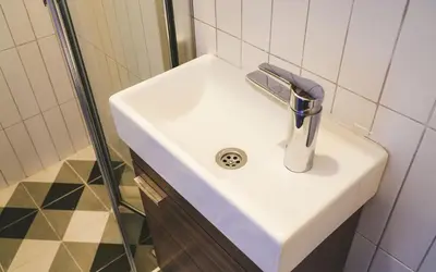 a white sink in a bathroom with a shower at Hill House Hostel in Istanbul