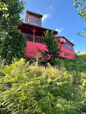 a red house sitting on top of a hill at Sapanca Kırmızı Hobbit Evi in Sapanca