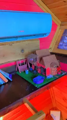 a table with a toy house on top of it at Sapanca Kırmızı Hobbit Evi in Sapanca