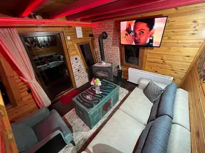 a living room with a couch and a tv at Sapanca Kırmızı Hobbit Evi in Sapanca