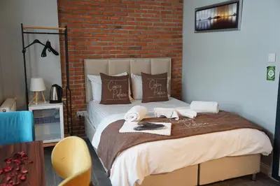a bedroom with a bed with towels and a brick wall at The İstanbul Levent Çakra Palace in Istanbul