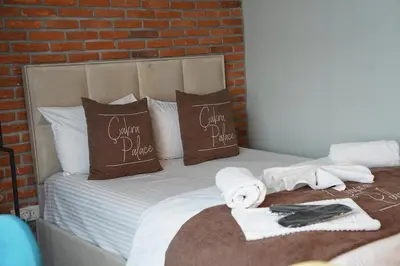 a bed with two pillows and towels on it at The İstanbul Levent Çakra Palace in Istanbul